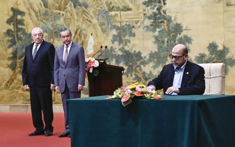 Mussa Abu Marzuk, a senior member of Hamas, signs a Palestinian unity agreement in Beijing. AP