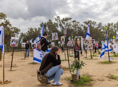 People visit the site of the Supernova music festival massacre in Re'im, January 14, 2024. (Chaim Goldberg/Flash90)