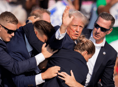 Republican presidential candidate former President Donald Trump is helped off the stage by U.S. Secret Service agents at a campaign event in Butler, Pa., on July 13, 2024.