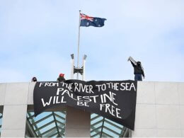 Protesters hang banners from the top of Parliament House in Canberra, Australia, Thursday, July 4, 2024. Reuters