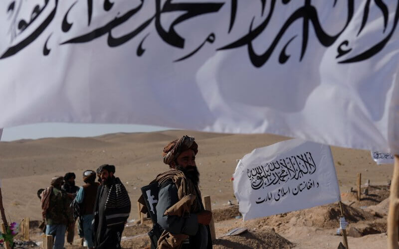 Taliban soldiers walk in a cemetery of victims of the recent earthquake in the district of Zinda Jan, in Herat, Afghanistan October 10, 2023. Reuters