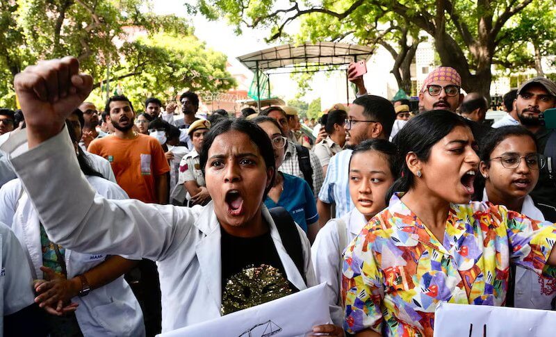 Protesters gather in front of the Indian health minister's office in New Delhi. AP