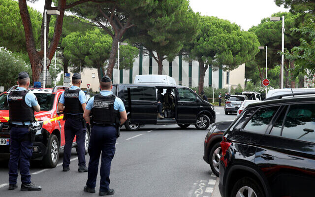 Law enforcement officers stand in front of a synagogue following a fire and explosion of cars in La Grande-Motte, south of France, on August 24, 2024. AFP