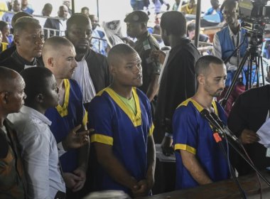 Tyler Thompson, Marcel Malanga and Benjamin Reuben Zalman-Polun face the court in Kinshasa, Congo. AP