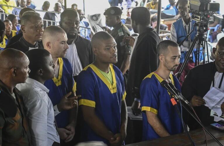 Tyler Thompson, Marcel Malanga and Benjamin Reuben Zalman-Polun face the court in Kinshasa, Congo. AP