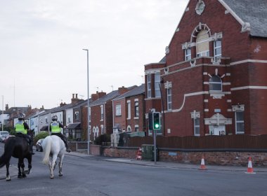 Mounted police officers patrol outside Southport Islamic Centre Mosque after unrest. PA