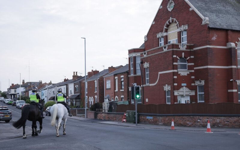 Mounted police officers patrol outside Southport Islamic Centre Mosque after unrest. PA