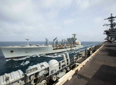 The USNS Big Horn sails alongside the USS Abraham Lincoln during a replenishment-at-sea on Sept. 11, 2024. US Navy