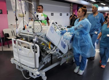 Medical staff at Haifa’s Rambam Medical Center transport a patient from the upper floors after Lebanon’s Hezbollah fired rockets on northern Israel. AFP