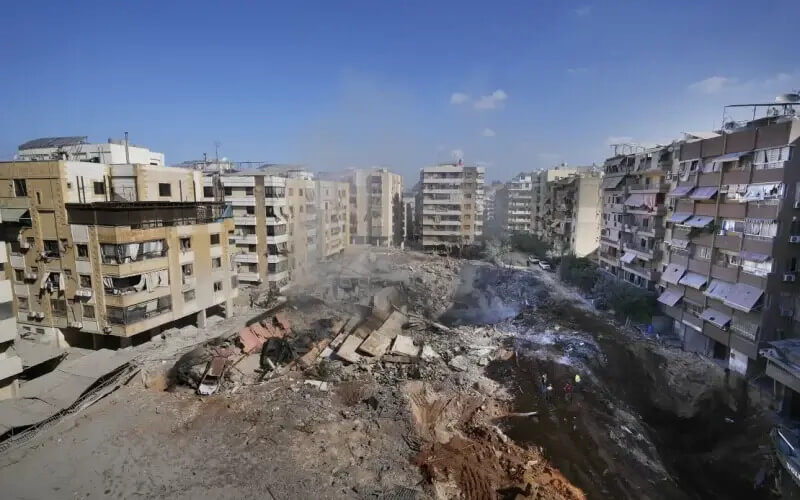 People gather at the site of the assassination of Hezbollah’s leader Hassan Nasrallah in Beirut’s southern suburbs. AP