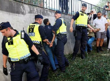 Swedish police intervene during opposition to the burning of the Quran in Stockholm. Reuters