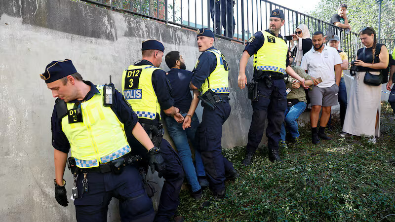 Swedish police intervene during opposition to the burning of the Quran in Stockholm. Reuters