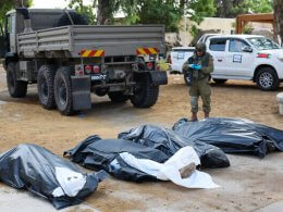 A soldier prepares to remove the bodies of Israelis murdered on October 7, 2023. AFP