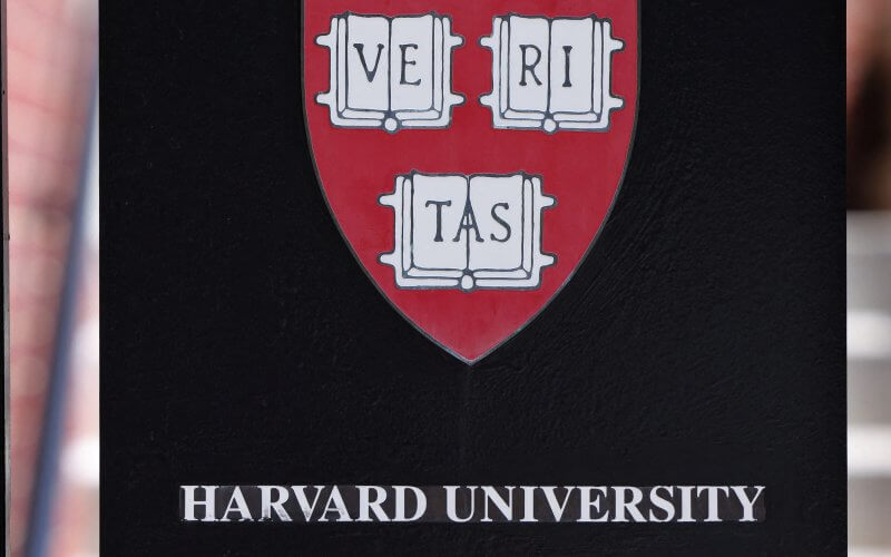 A sign hangs on a gate of a building at Harvard University in Cambridge, Massachusetts, U.S., July 6, 2023. Reuters