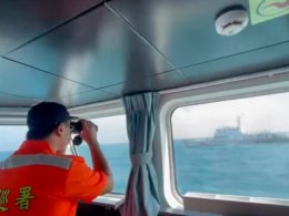 A member of the Taiwan Coast Guard monitors a China Coast Guard vessel. AP