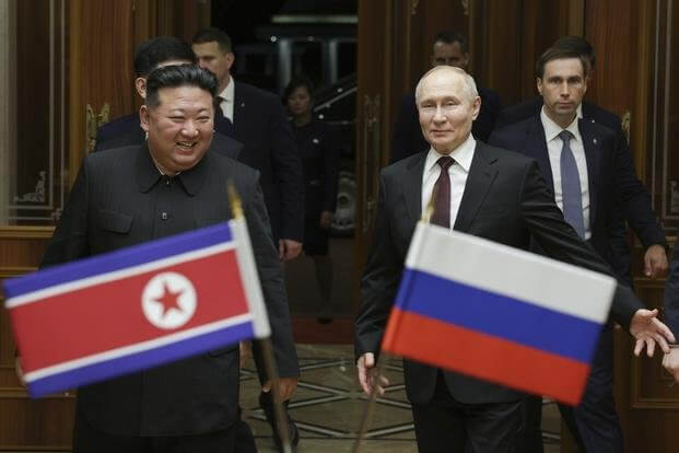 Russian President Vladimir Putin and North Korea's leader Kim Jong Un at the Pyongyang Sunan International Airport outside Pyongyang. Sputnik