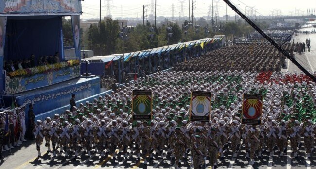 Regime soldiers march in a military parade. AFP