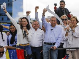 Opposition leader Maria Corina Machado and candidate Edmundo Gonzalez hold vote tally sheets. AP