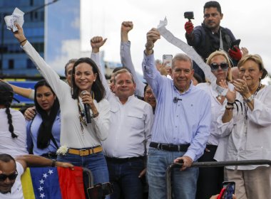 Opposition leader Maria Corina Machado and candidate Edmundo Gonzalez hold vote tally sheets. AP