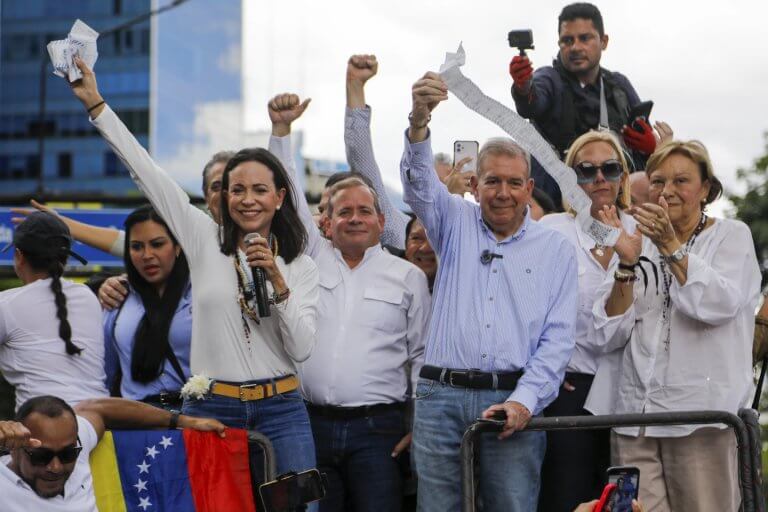 Opposition leader Maria Corina Machado and candidate Edmundo Gonzalez hold vote tally sheets. AP