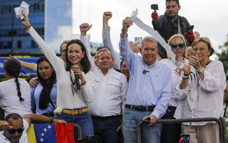 Opposition leader Maria Corina Machado and candidate Edmundo Gonzalez hold vote tally sheets. AP