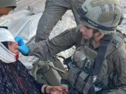 Cpl. Shai Gilboa treats a woman in Gaza. twitter.com