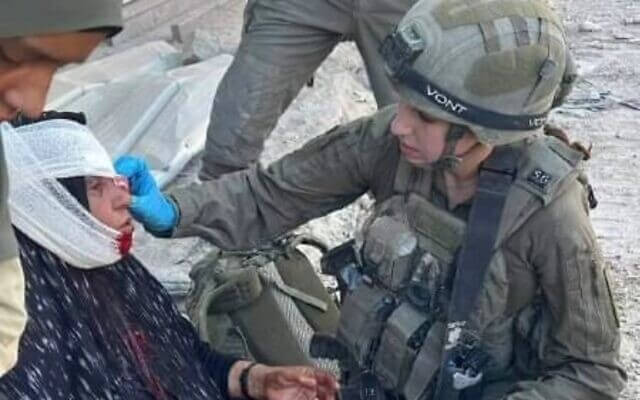 Cpl. Shai Gilboa treats a woman in Gaza. twitter.com