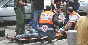 Israeli medics help people wounded during a 2006 suicide attack in Tel Aviv. Reuters