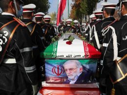 Military personnel stand near the coffin of Mohsen Fakhrizadeh during his funeral in Tehran. AP