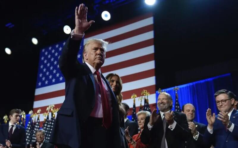 Republican presidential nominee former President Donald Trump and former first lady Melania Trump walk on stage at an election night watch party at the Palm Beach Convention Center. AP