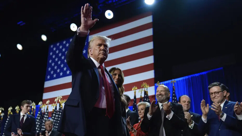 Republican presidential nominee former President Donald Trump and former first lady Melania Trump walk on stage at an election night watch party at the Palm Beach Convention Center. AP