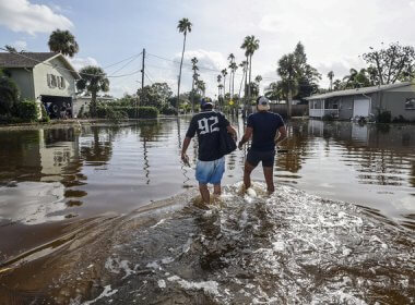 Florida residents walk through floodwaters from Hurricane Helene in Florida. AP