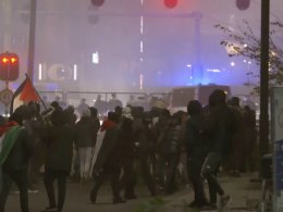 Anti-Israel protesters walk towards a police line in Amsterdam. AP