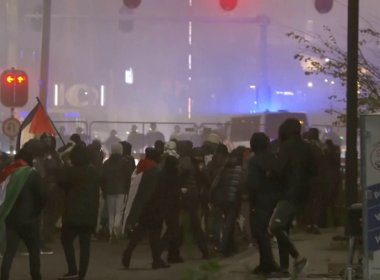 Anti-Israel protesters walk towards a police line in Amsterdam. AP