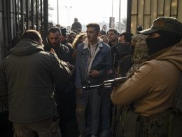 Former Syrian soldiers wait to apply for amnesty consideration in Damascus. AP