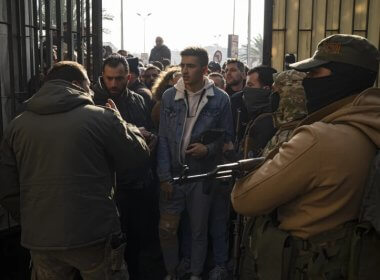 Former Syrian soldiers wait to apply for amnesty consideration in Damascus. AP