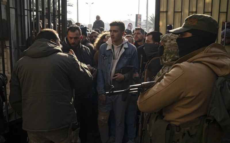 Former Syrian soldiers wait to apply for amnesty consideration in Damascus. AP