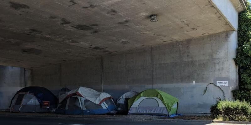 A homeless encampment under an underpass in 2018. wikimedia.org