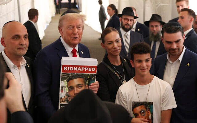 Donald Trump poses for photos with family members of Hamas hostage Edan Alexander. AP