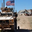 A U.S. soldier sits on an armored vehicle in northern Syria. AP