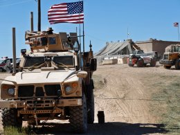 A U.S. soldier sits on an armored vehicle in northern Syria. AP