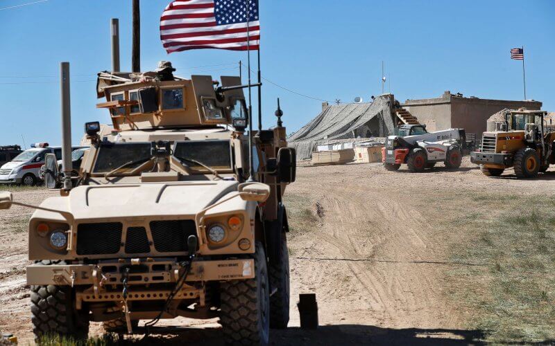 A U.S. soldier sits on an armored vehicle in northern Syria. AP