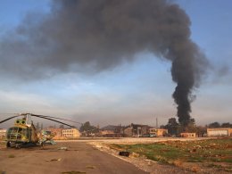 A destroyed Syrian army helicopter sits on the tarmac the Nayrab military airport in the northern Syrian city of Aleppo on December 2, 2024. AFP