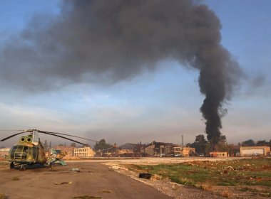 A destroyed Syrian army helicopter sits on the tarmac the Nayrab military airport in the northern Syrian city of Aleppo on December 2, 2024. AFP