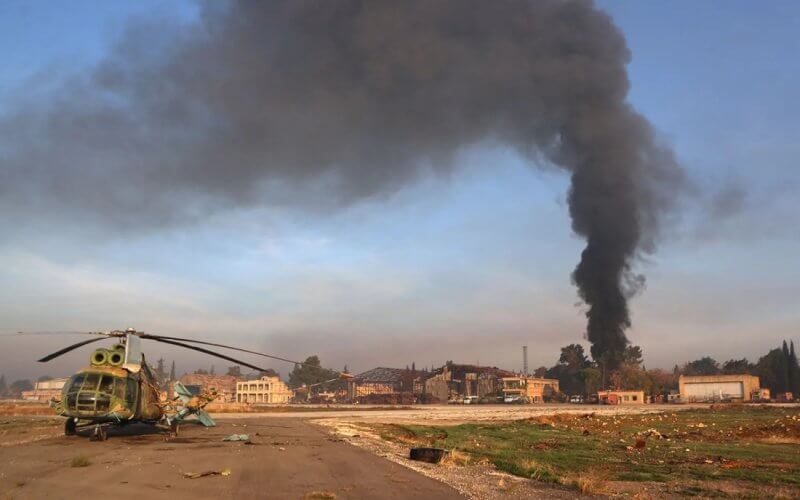 A destroyed Syrian army helicopter sits on the tarmac the Nayrab military airport in the northern Syrian city of Aleppo on December 2, 2024. AFP