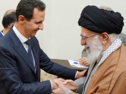 Syrian President Bashar al-Assad, left, shakes hands with the Islamic Republic's Supreme Leader Ali Khamenei. SANA