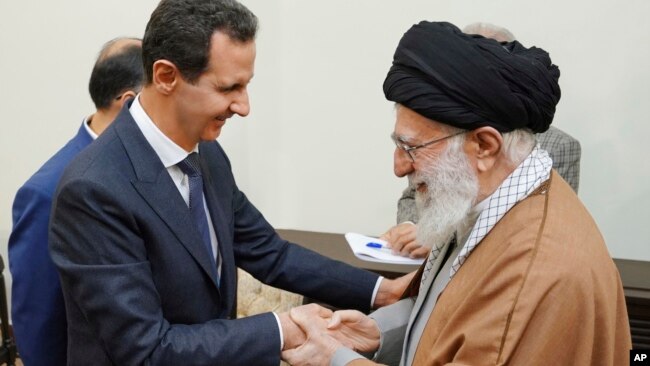 Syrian President Bashar al-Assad shakes hands with the Islamic Republic's Supreme Leader Ali Khamenei. SANA