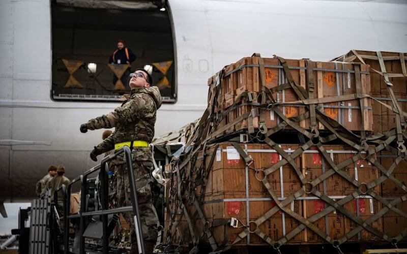 An airman with the 436th Aerial Port Squadron loads cargo during a Ukraine security assistance mission at Dover AFB. U.S. Air Force