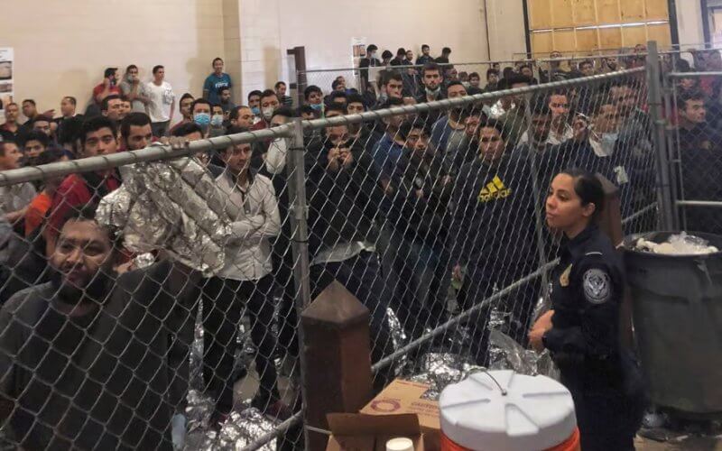 Men stand in a US Immigration and Border Enforcement detention center in McAllen, Texas. AP