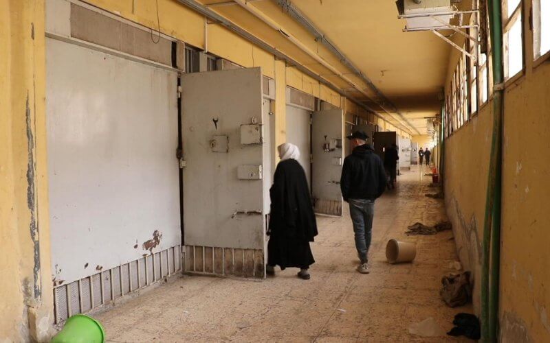 Syrians walking through the halls of the Sednaya prison. news.sky.com